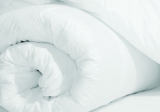 A White Pillow On A Bed