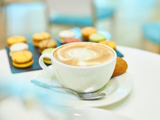 A Close Up Of A Coffee Cup On A Plate